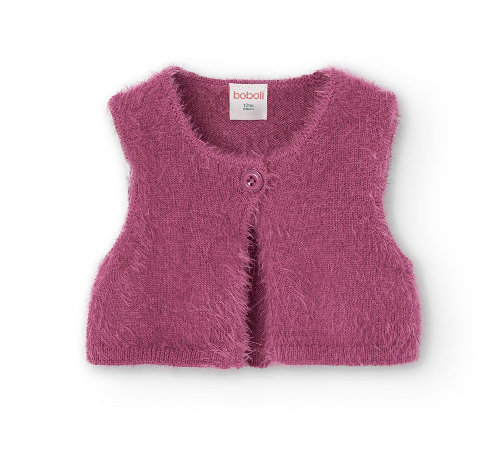 Questo gilet in maglia corto è l'ideale per aggiungere un tocco di calore e stile all'outfit dell...