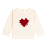 Felpa crema con cuore rosso e scritta, maniche larghe e girocollo.