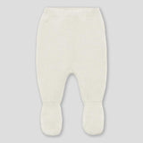 Pantalone bianco con piedini in maglia per neonata su fondo grigio