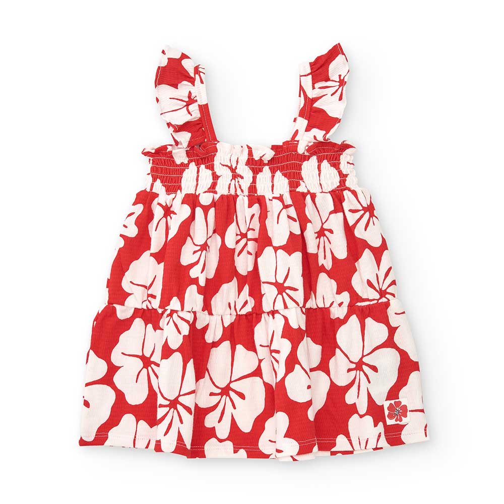 Kleidchen aus der Tuc Tuc Baby Clothing Line, aus Krepp mit Hibiskusmuster in Kontrastfarbe.
Zusa...