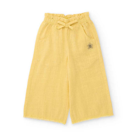 Pantaloni larghi gialli per bambina con elastico in vita e tasche.