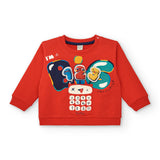 Felpa rossa per bambini con stampa colorata e applicazioni divertenti.
